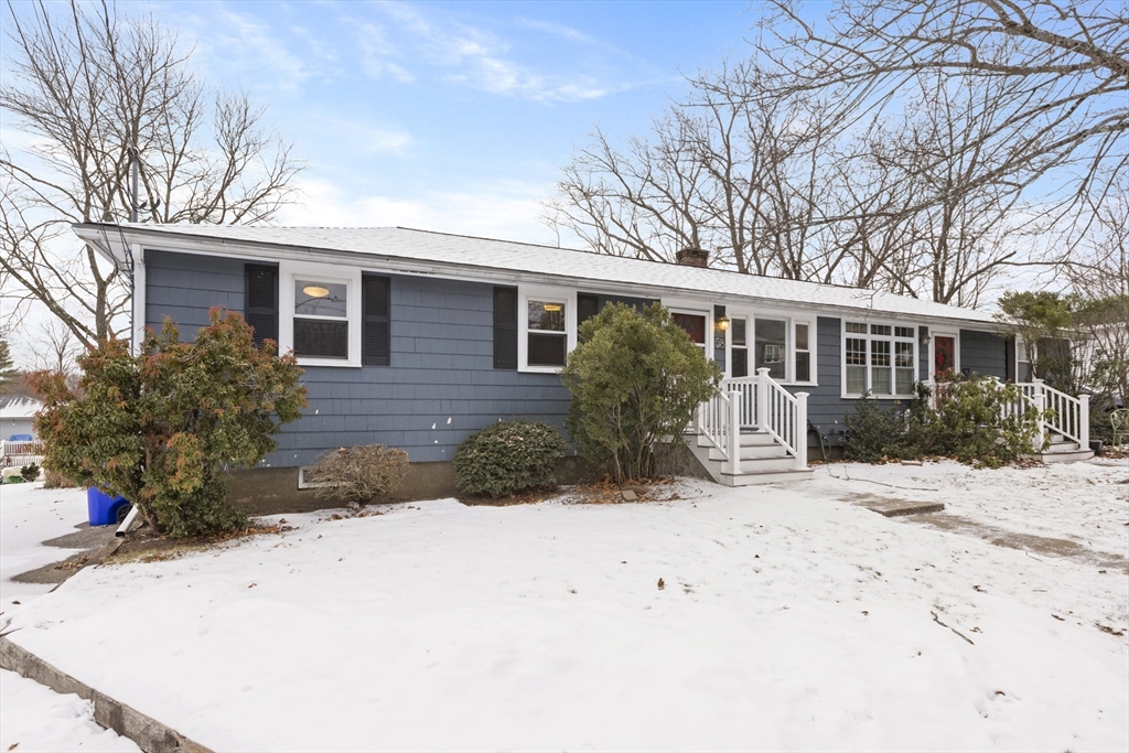 58 Neillian Way, Unit 58 Bedford, MA 01730 - Photo 21 of 23 a view of a house with a yard covered in snow