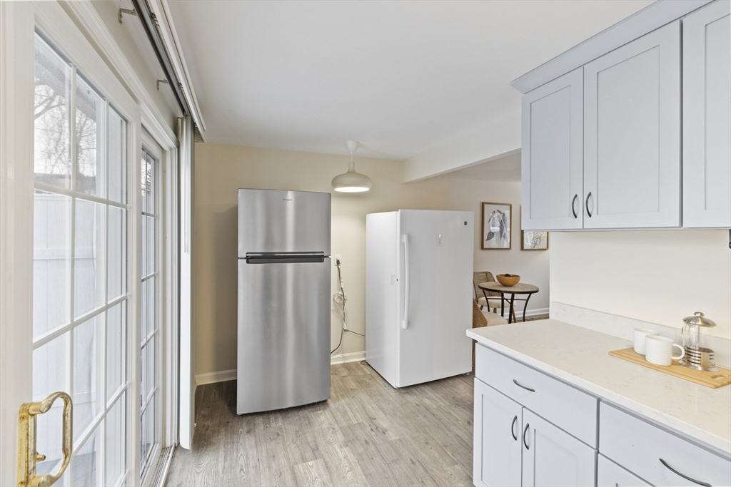 58 Neillian Way, Unit 58 Bedford, MA 01730 - Photo 6 of 23 a kitchen with stainless steel appliances granite countertop a refrigerator and a sink