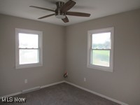 6439 Wadsworth Road Medina, OH 44256 - Photo 11 of 14 Empty room with dark colored carpet and a ceiling fan