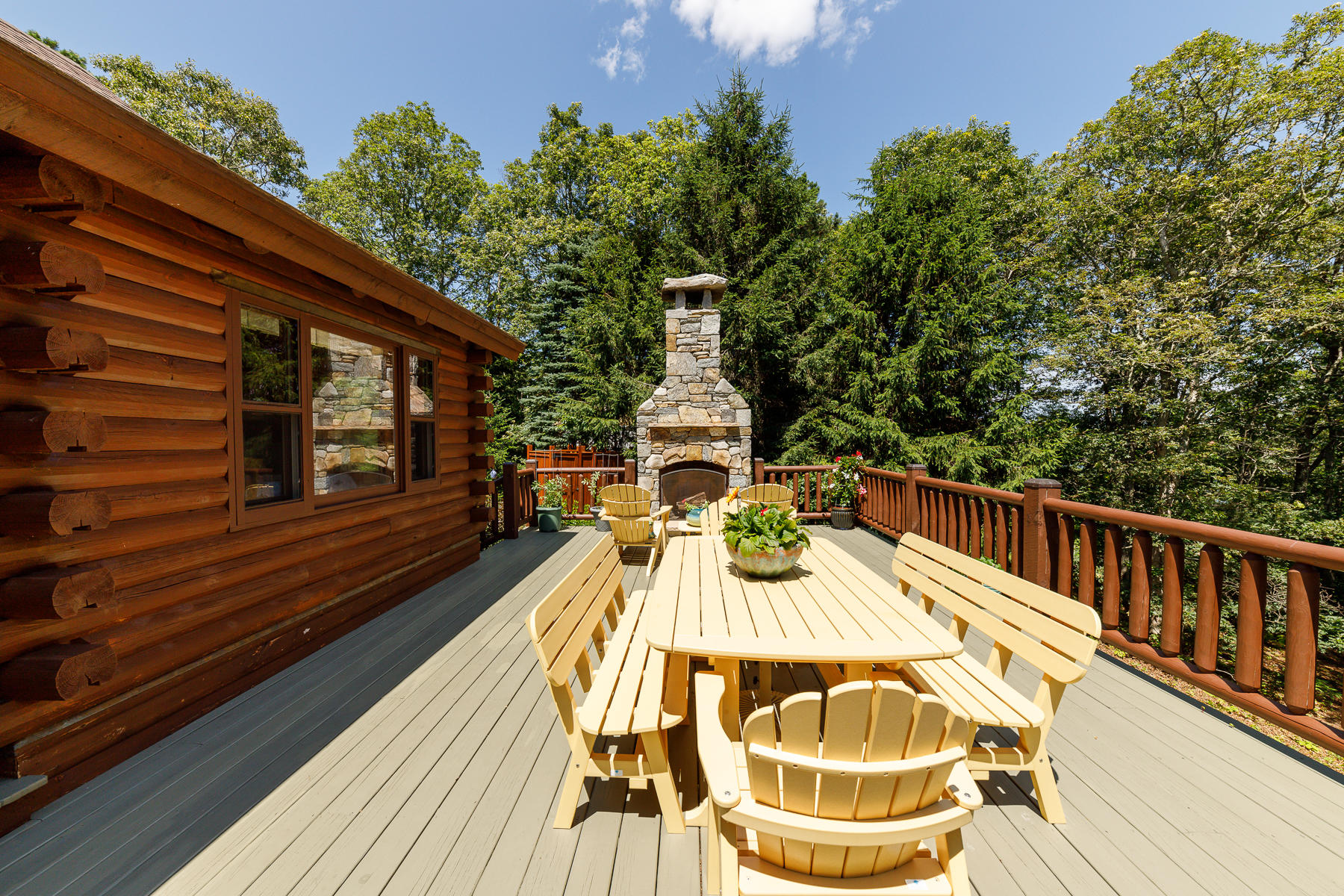 252 Valley Road Plymouth, MA 02360 - Photo 29 of 78 a view of a roof deck with table and chairs with wooden floor