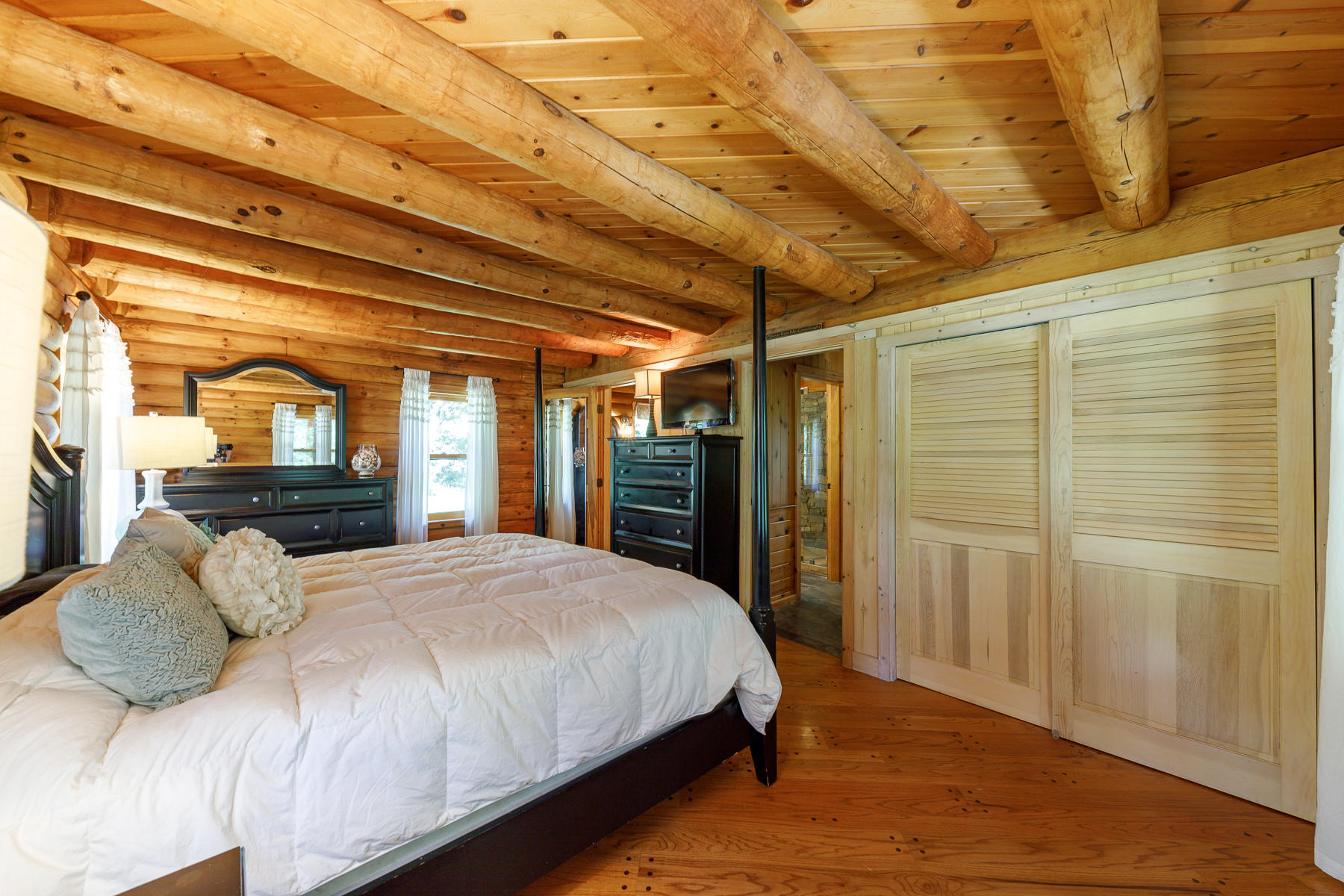 252 Valley Road Plymouth, MA 02360 - Photo 33 of 78 a bedroom with a large bed and wooden floor