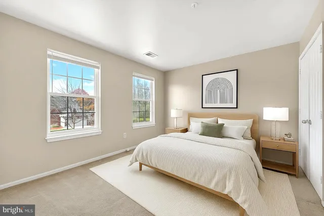 a bedroom with a large bed and a window