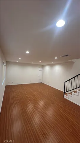 a view of room and hall with wooden floor