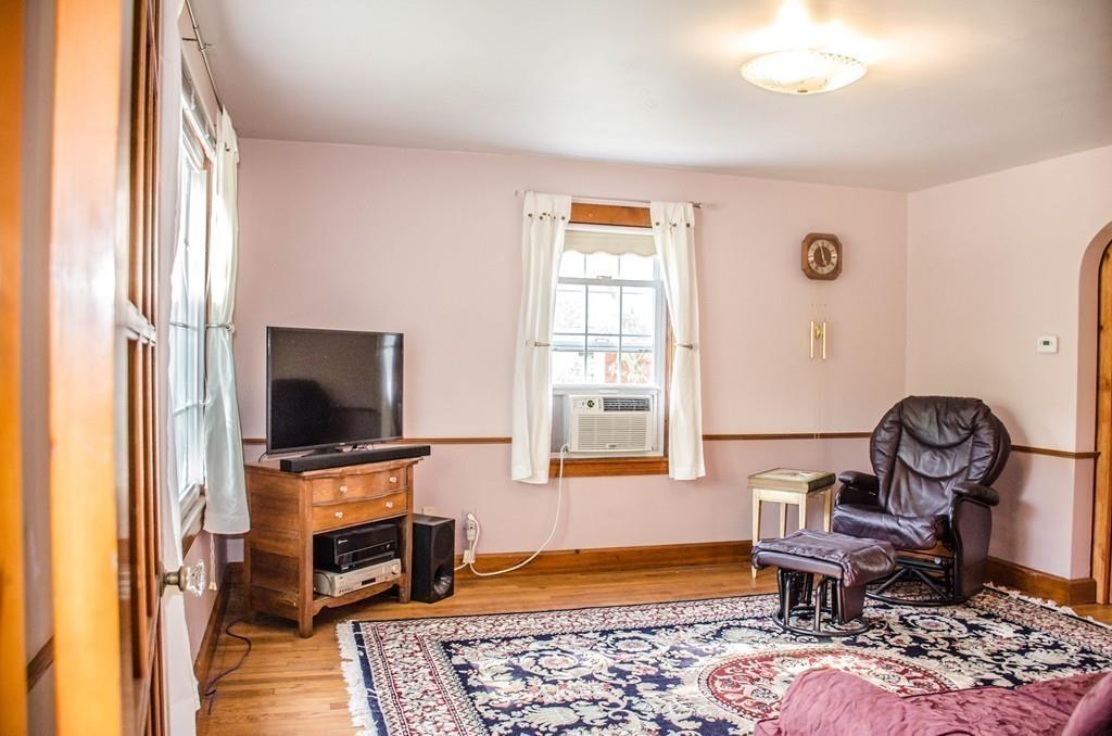 183 Lancaster Road Berlin, MA 01503 - Photo 15 of 41 a living room with furniture and a flat screen tv