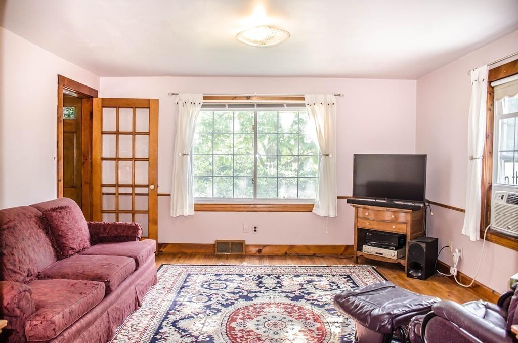 183 Lancaster Road Berlin, MA 01503 - Photo 16 of 41 a living room with furniture and a flat screen tv