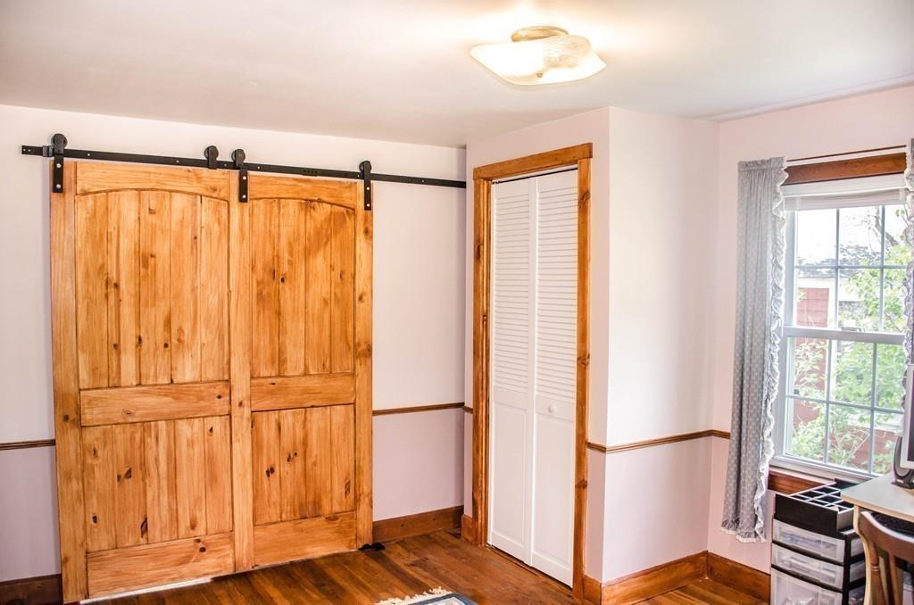 183 Lancaster Road Berlin, MA 01503 - Photo 20 of 41 a view of a bedroom with furniture and a window