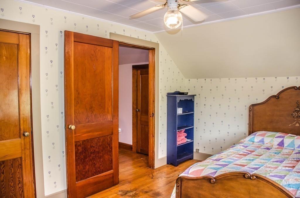 183 Lancaster Road Berlin, MA 01503 - Photo 24 of 41 a bedroom with a bed and a chandelier
