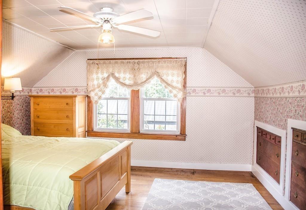 183 Lancaster Road Berlin, MA 01503 - Photo 26 of 41 a spacious bedroom with a bed and a chandelier