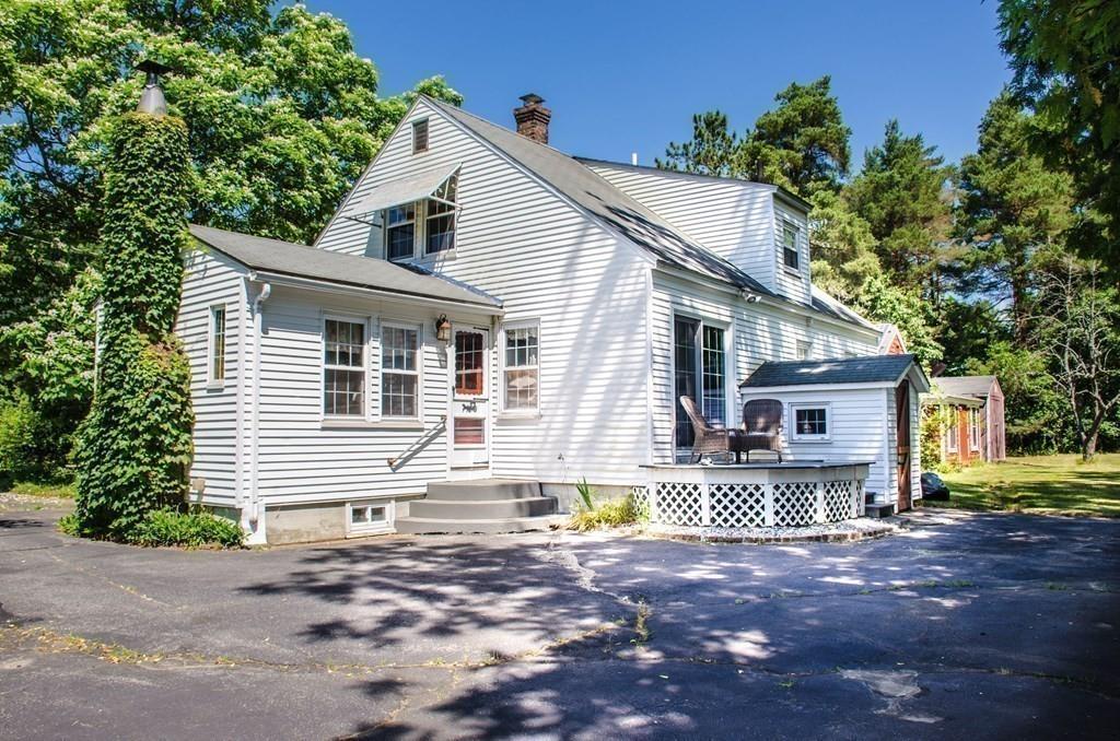 183 Lancaster Road Berlin, MA 01503 - Photo 32 of 41 a front view of a house with a yard and potted plants
