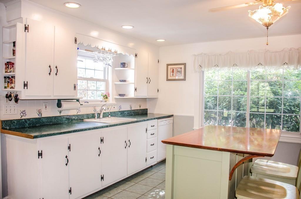 183 Lancaster Road Berlin, MA 01503 - Photo 6 of 41 a kitchen with granite countertop a sink and white cabinets