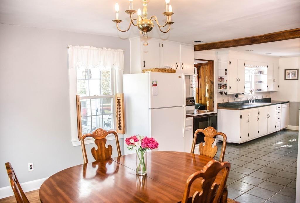 183 Lancaster Road Berlin, MA 01503 - Photo 9 of 41 a view of a dining room with furniture a chandelier and wooden floor