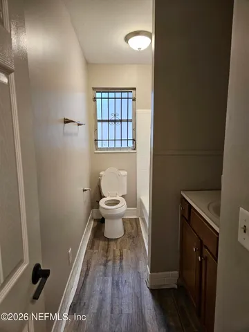 a bathroom with a toilet and a mirror