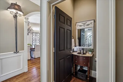 a view of a hallway with wooden floor and furniture