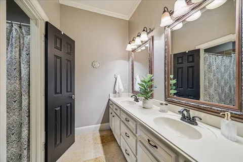 a bathroom with a double vanity sink and a mirror