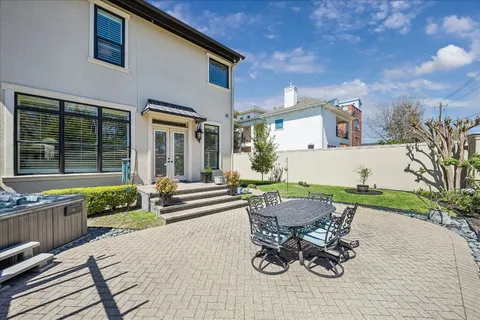 a view of a house with patio and a yard