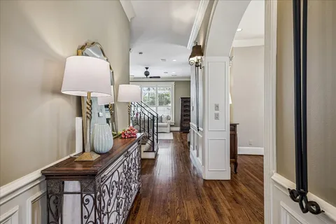 a hallway with furniture and wooden floor