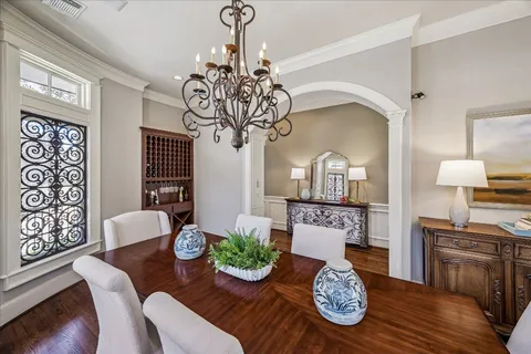 a view of a dining room with furniture wooden floor and chandelier
