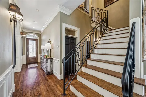 a view of entryway and hall with wooden floor