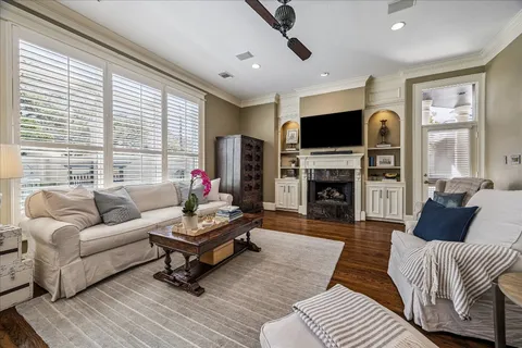 a living room with furniture a flat screen tv and a fireplace