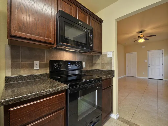 a kitchen with a stove and a microwave