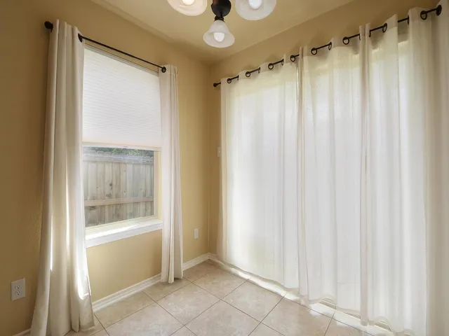 a view of a bathroom with a shower and a window
