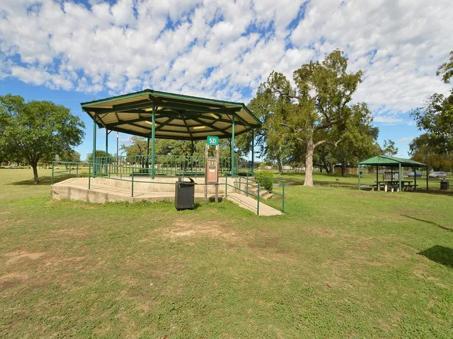 a view of a park with swings and slides