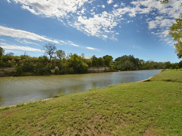 a city street lined with parked cars and buildings