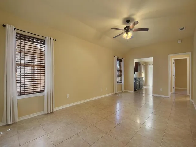 a view of a livingroom with a ceiling fan and window