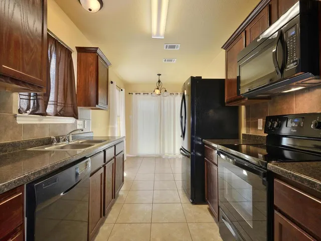 a kitchen with a refrigerator stove and sink