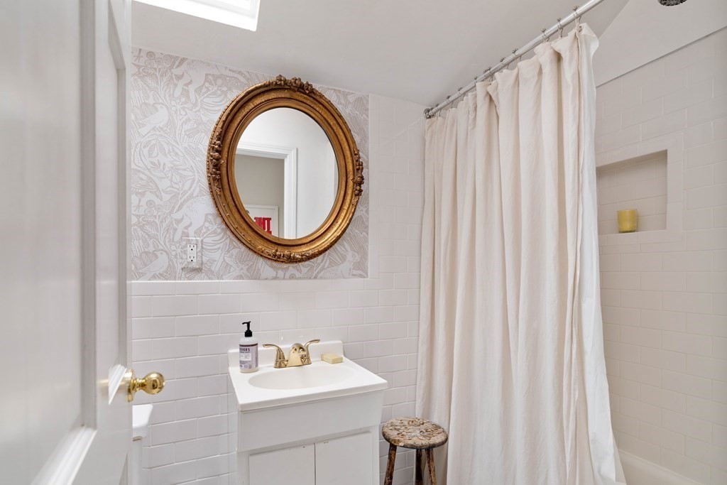 27 White Place Brookline, MA 02445 - Photo 16 of 17 a bathroom with a sink and a mirror