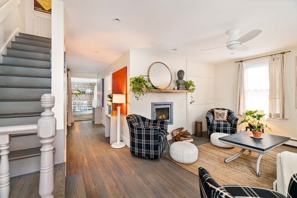 27 White Place Brookline, MA 02445 - Photo 3 of 17 a living room with furniture a fireplace and a large window