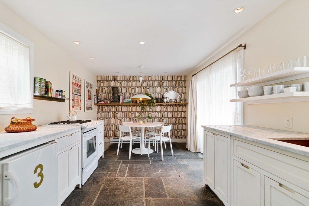 27 White Place Brookline, MA 02445 - Photo 6 of 17 a kitchen with stainless steel appliances granite countertop a sink and cabinets