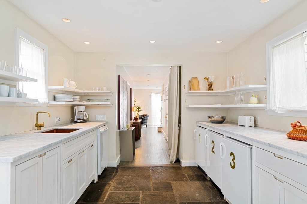 27 White Place Brookline, MA 02445 - Photo 8 of 17 a kitchen with a sink a refrigerator and cabinets
