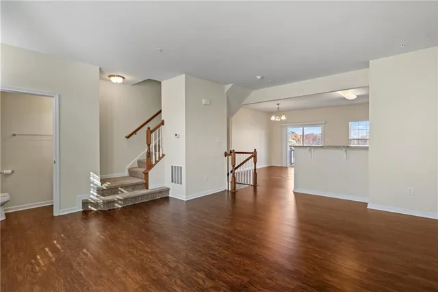 a view of a room with wooden floor and windows