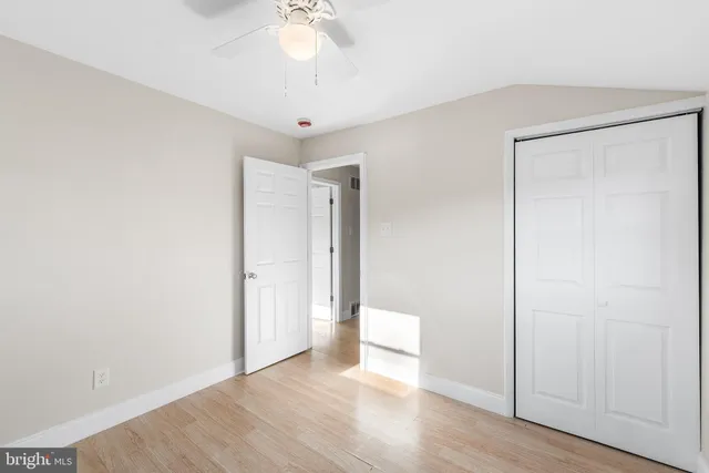 a view of an empty room and wooden floor