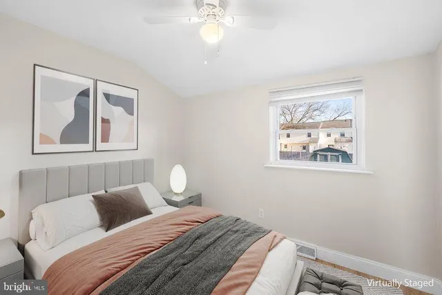 a bedroom with a bed and a painting on the wall