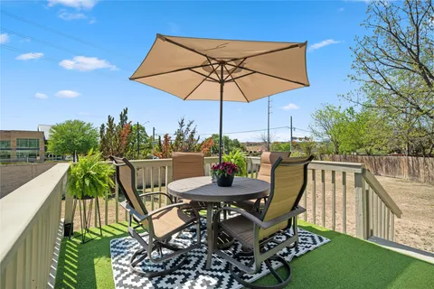 a patio with a patio table and chairs