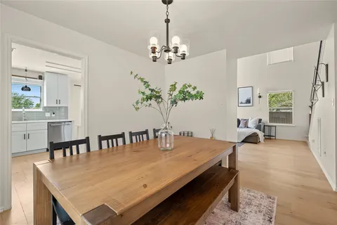 a view of a dining room with furniture and chandelier