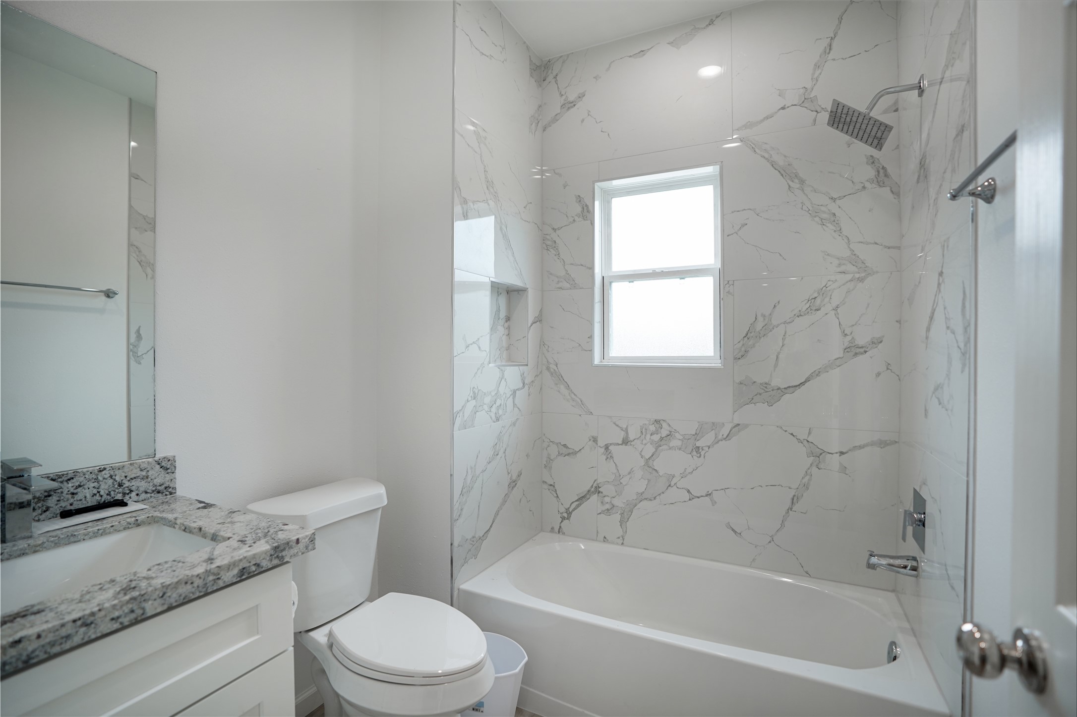 7914 Laura Koppe Road, Unit A Houston, TX 77028 - Photo 12 of 14 a bathroom with a granite countertop toilet sink and bathtub