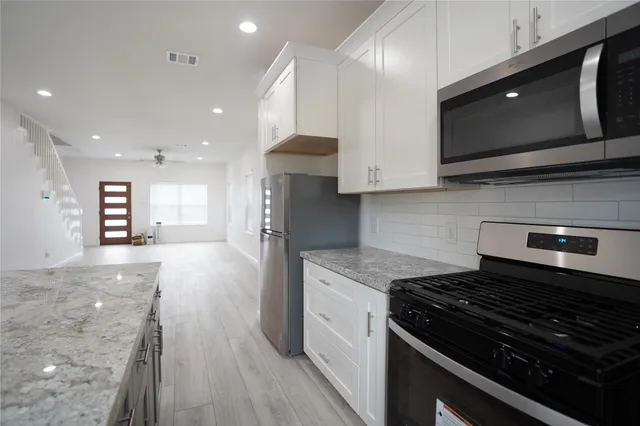 a kitchen with a stove and a microwave