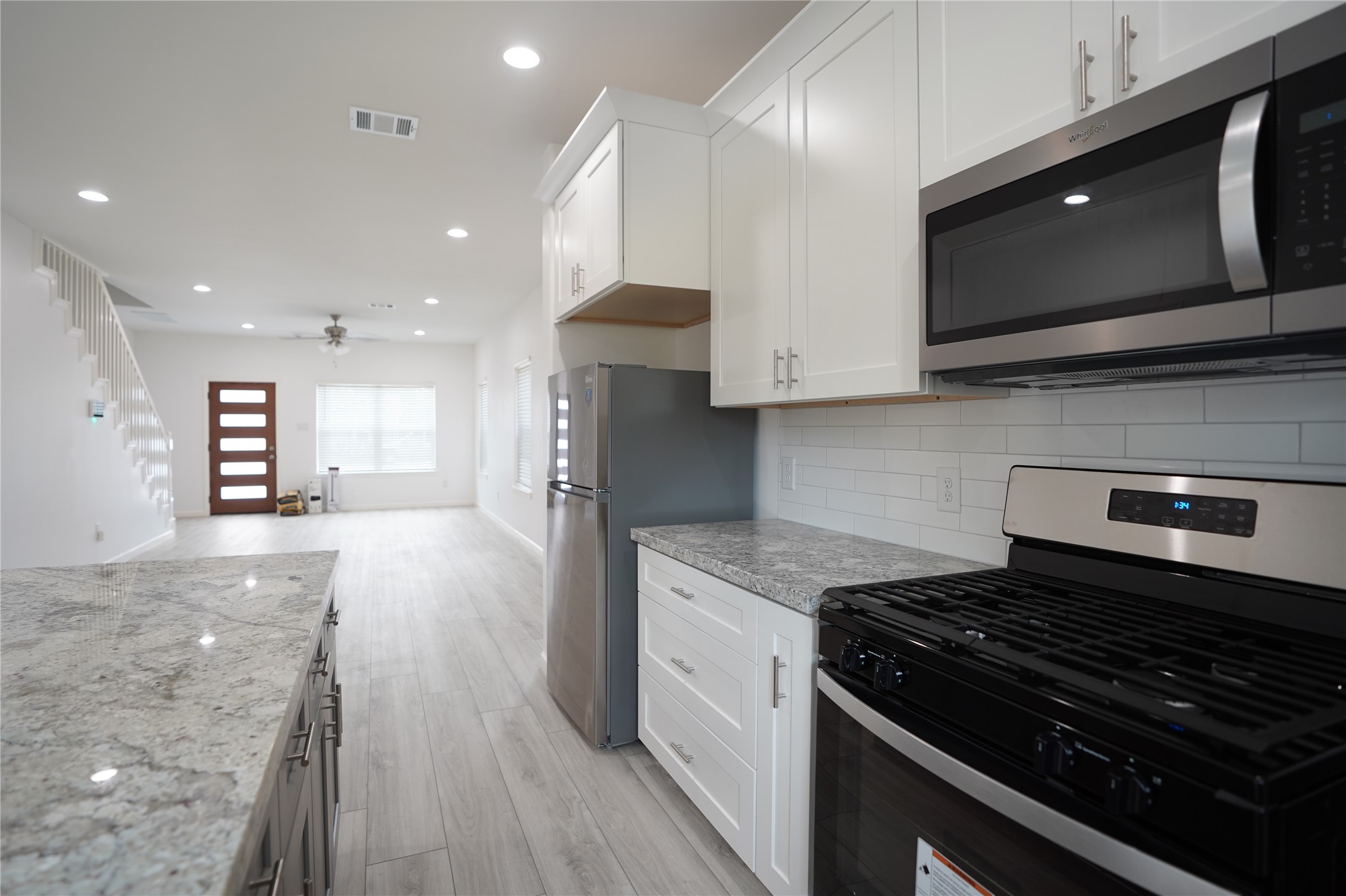 7914 Laura Koppe Road, Unit A Houston, TX 77028 - Photo 6 of 14 a kitchen with a stove and a microwave