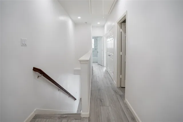 a view of a hallway with wooden floor