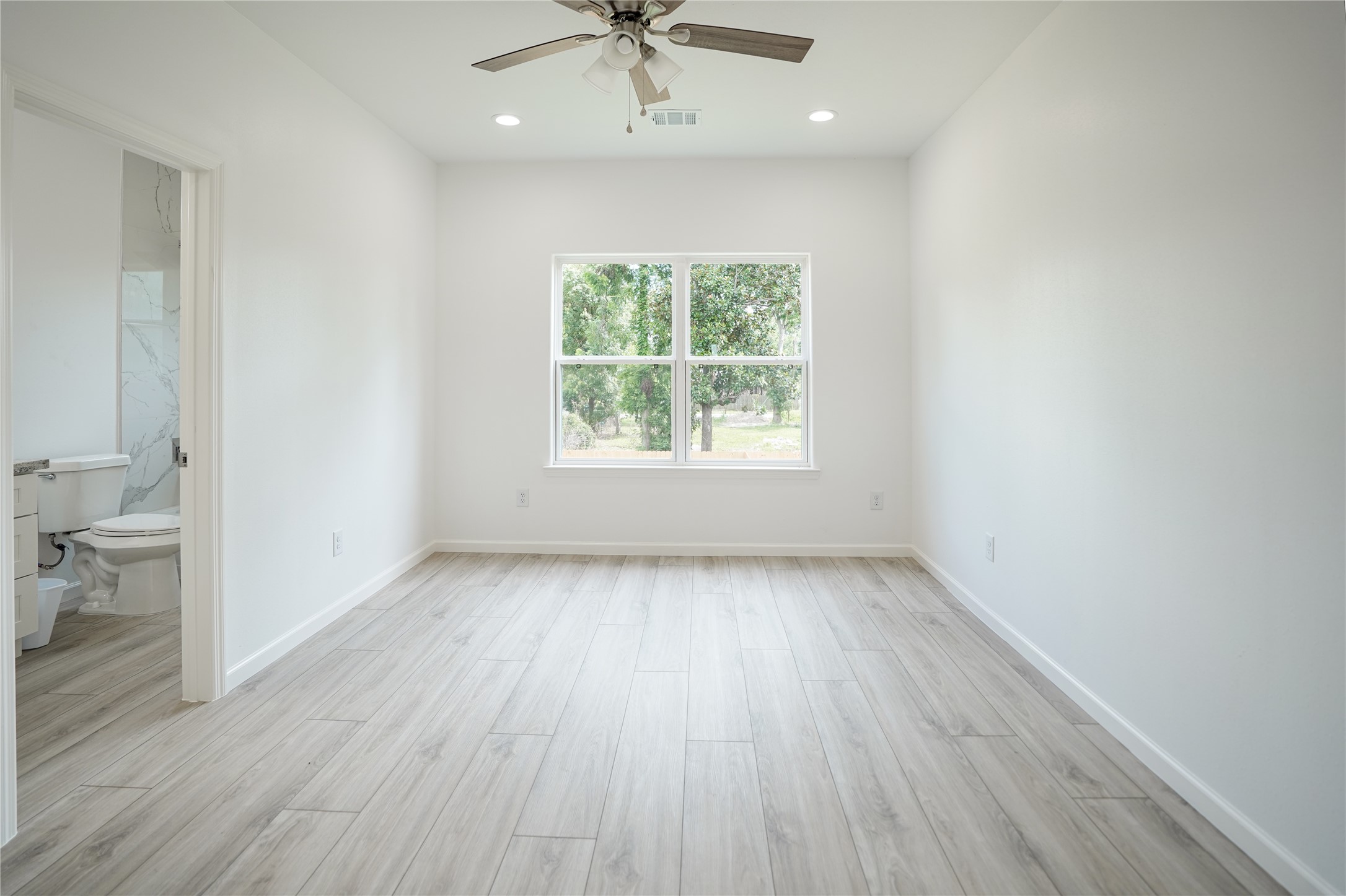 7914 Laura Koppe Road, Unit A Houston, TX 77028 - Photo 8 of 14 wooden floor in an empty room with a window