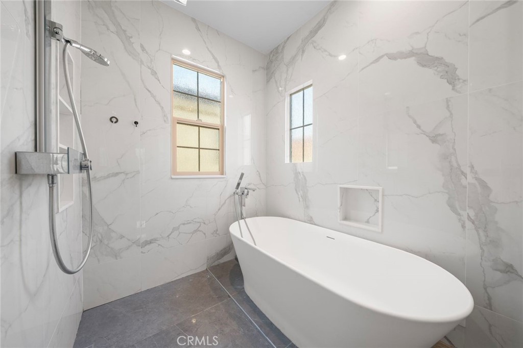 109 Soaring Eagle Irvine, CA 92618 - Photo 20 of 41 a bathroom with a white bath tub sitting next to a window