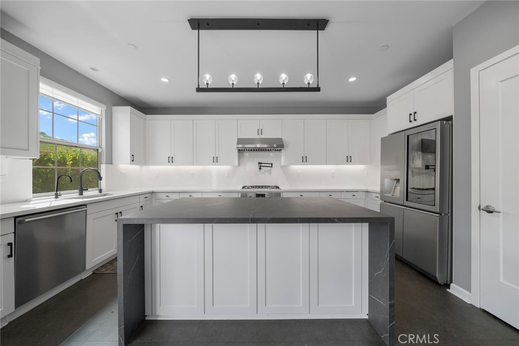 109 Soaring Eagle Irvine, CA 92618 - Photo 5 of 41 a kitchen with stainless steel appliances granite countertop a sink and cabinets