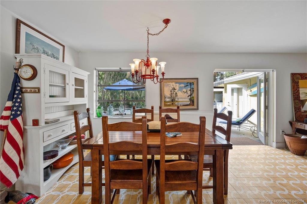 111 South Sewalls Point Road Stuart, FL 34996 - Photo 23 of 60 a view of a dining room with furniture and a chandelier