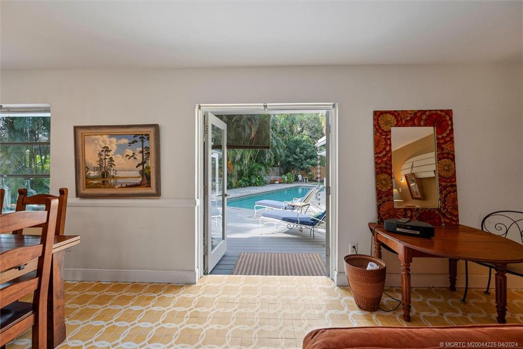 111 South Sewalls Point Road Stuart, FL 34996 - Photo 25 of 60 a living room with furniture and a floor to ceiling window