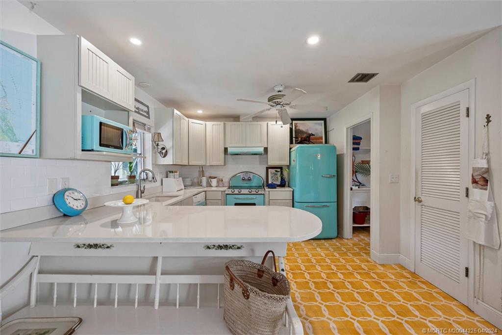 111 South Sewalls Point Road Stuart, FL 34996 - Photo 26 of 60 a large kitchen with a table and chairs