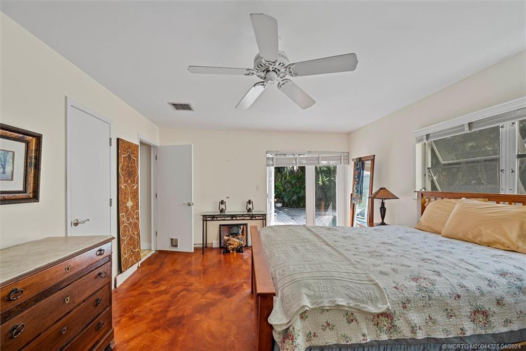 111 South Sewalls Point Road Stuart, FL 34996 - Photo 31 of 60 a large bedroom with a bed and wooden floor