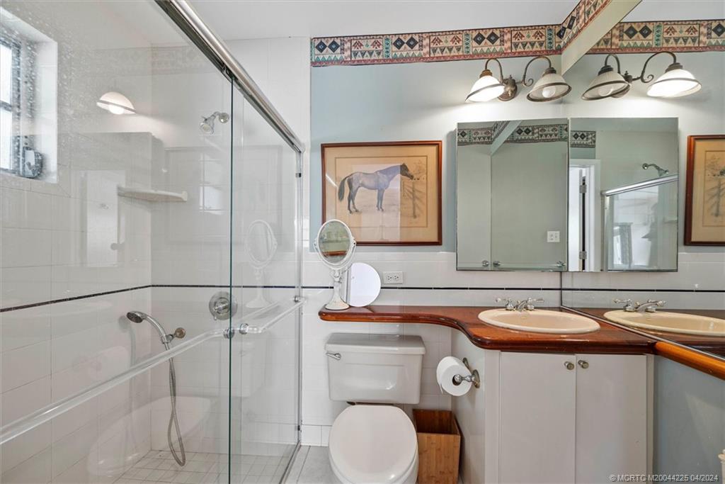 111 South Sewalls Point Road Stuart, FL 34996 - Photo 34 of 60 a bathroom with a sink and a mirror
